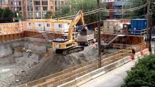 CAT excavator loading dump trucks