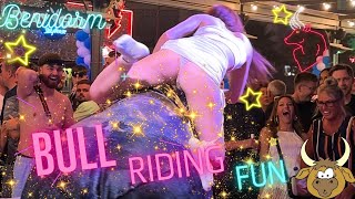 Girl In a White Shiny Dress Riding on a Mechanical Bull in Benidorm 4K