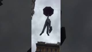 weird man holding an umbrella in prague