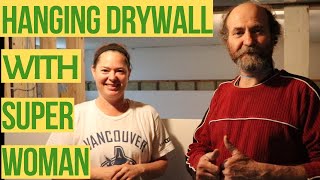 INSTALLING drywall with SUPER WOMAN