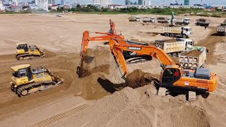 The best construction equipment Excavator diging sand and heavy dump truck / dozer pushing sand