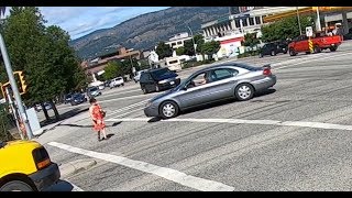 Turning car almost hits woman