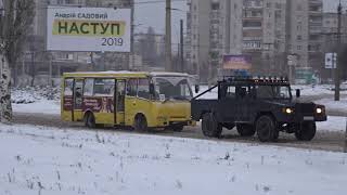 A miracle machine, pulling a broken Bohdan A 092 bus, a minibus in trouble.