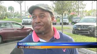 Man takes golf swing at used car salesman