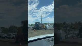 Road grader flattens road