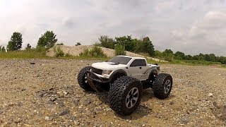 Hpi Savage Xs Ford Raptor off-road in gravel, dirt, mulch.