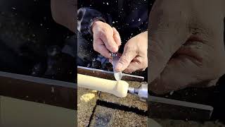 Craftsman making drumsticks on the street