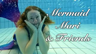 Mermaid friends swim in deep pool