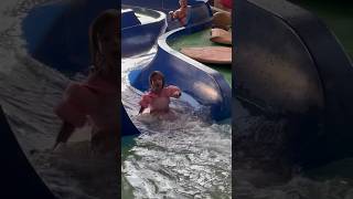 Daddy follows baby down the blue slide at Great Wolf Lodge