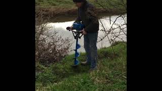 Using earth auger to plant trees