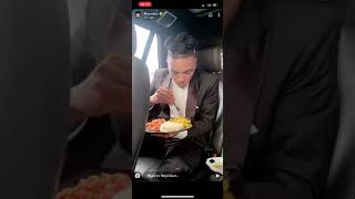 Mayorkun eating yam and egg in his car