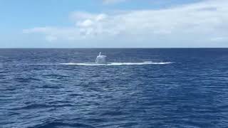 Atlantis submarine surfacing for boarding - Waikiki, Oahu, Hawaii.