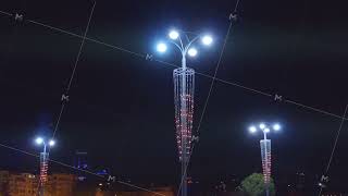 Beautiful lanterns lighting city street at night on black sky background. Stock footage. Street