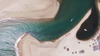 4K Cinematic Drone Footage: Soar Above the Crystal Clear Waters of the Beach on a Sunny Day