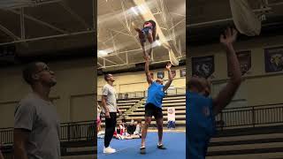 Cheerleaders are practicing a new coed skill!