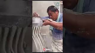 A Man Making Noodles With A Tool