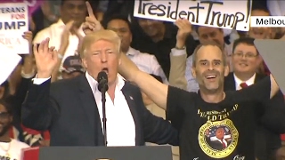 Trump hands the mic to a supporter at his Florida rally