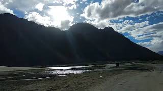 Driving in Desert in between Mountains and River.. Nubra Valley, Ladakh