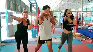 Vivi from Germany and Julie from China learn how to punch at MrLy Gym