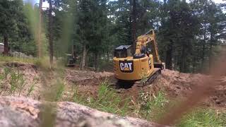 Removing topsoil and vegetation layer from this foundation excavation site