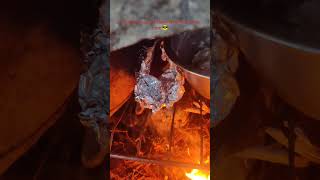 Smoking meat and baking in stone oven at camp