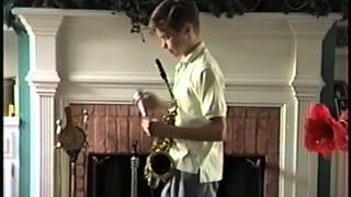 Young Bob Reynolds performs Jingle Bells on saxophone