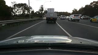 2021 white Mitsubishi Outlander, driving in the M4/Parramatta Road onramp shoulder