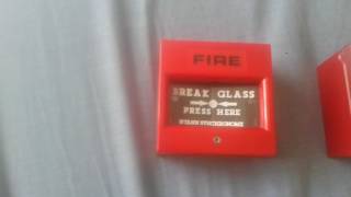 Breaking glass on fire alarm call points.