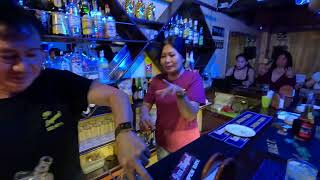 Harvey working at the Slouch. Hat Bar