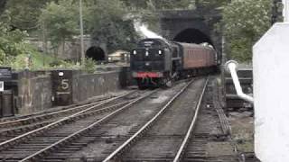 9F, 92214  clears the tunnel and enters Grosmont station on the NYMR.