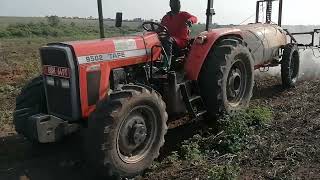 SPLAYING PLANTED FIELD USING ABOOM SPLAYER MOUNTED ON TRACTOR.