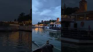 River Symphony: A Boat's Graceful Glide Past the Timeless Elegance of an Old Castle