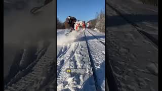 Snowmobile jumps railroad tracks