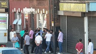 London, men fighting in street during Ramadan in front of Al Sham food shop no COVID 19 distancing