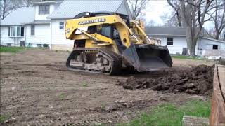 Deere 270 Skid Steer on VTS Tracks Pushing Pile Half Throttle