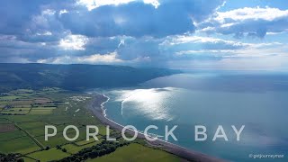 Porlock Bay & beyond. A Beacon to a Point across a Bay under a stormy summer sky. Experience Exmoor.