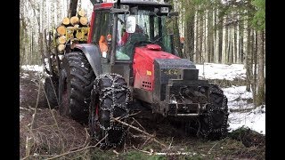 Valtra  forestry tractor logging in wet winter forest