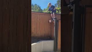 Oliver jumping off the fence parkour