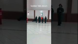 soldier falls down while playing trumpet