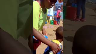 Feeding children with food in Dzaleka Refugee Camp.