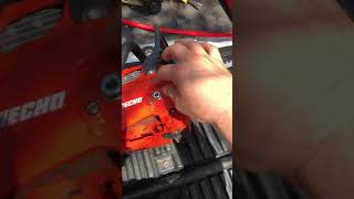 Putting on chain saw bar chain