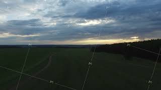 Beautiful sunset reflected in the field. Footage. Dramatic sunset over field aerial view. Beautiful