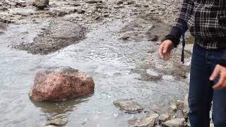 Rolling a giant rock into the river