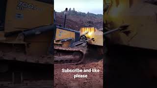 Cat Dozer pushing big rock