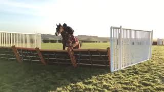 Peur De Rien and Tom Garner (red cap) schooling on the Lambourn grass gallops