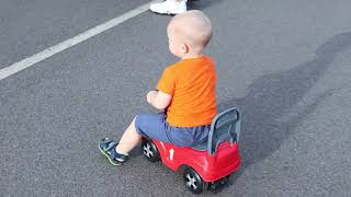 Daily walk outdoors on his red toy car