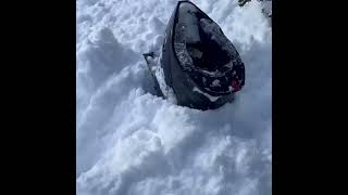 A powerful avalanche covered people on snowmobiles, USA.