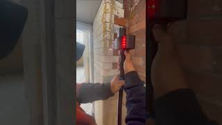 Laser cleaning demo - adhesive on glazed bricks inside an old mill being converted to apartments.