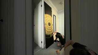 Artist is painting a calligraffiti design on a door with gold metallic paint!