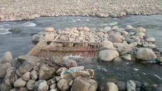 A unique fish trap (Chaja) made from wooden sticks in a stream.